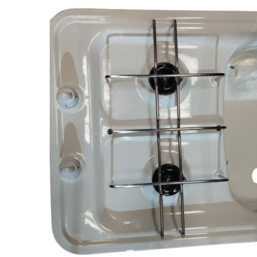 Detalle de la cocina Smev 958 blanca con perillas de control y quemadores de gas